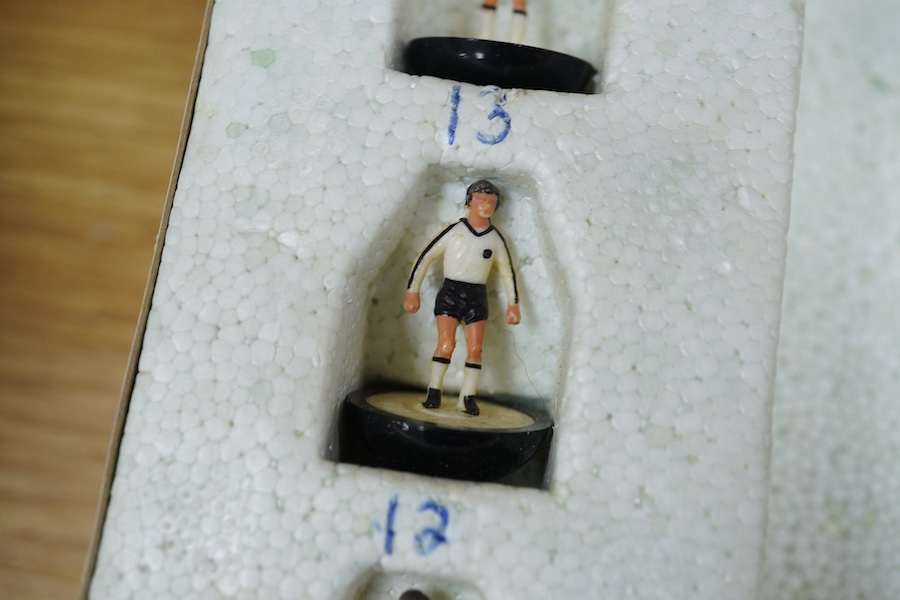 Two boxed Subbuteo table football sets; a European Edition, comprising of two teams, spectators and line side staff, pitch, etc. (some parts missing), and an International Edition, comprising of three teams, stadium ligh